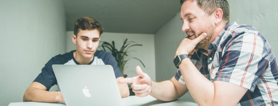 a man and boy at a computer
