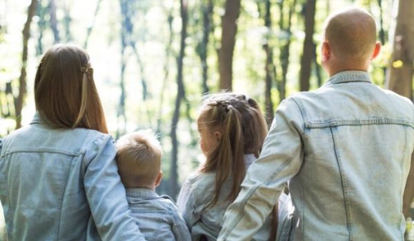 a family of four in the forest