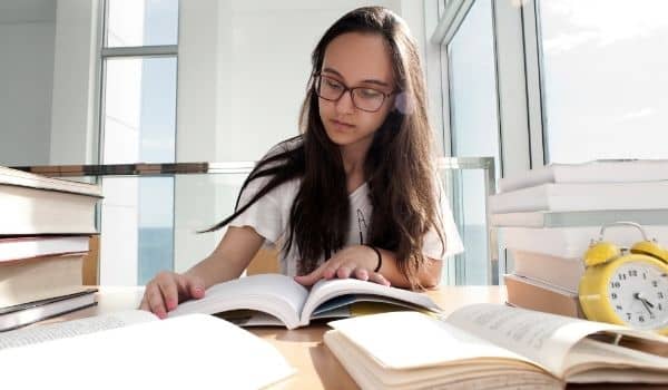 a young woman learning dutch at her table