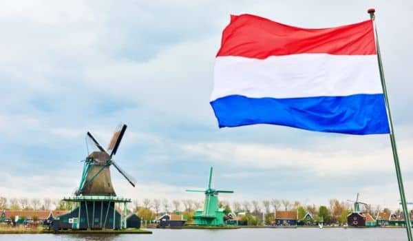 Why ISn;t the Dutch Flag Orange? A Picture of a red, white and blue ducth flag with a windmill in the background