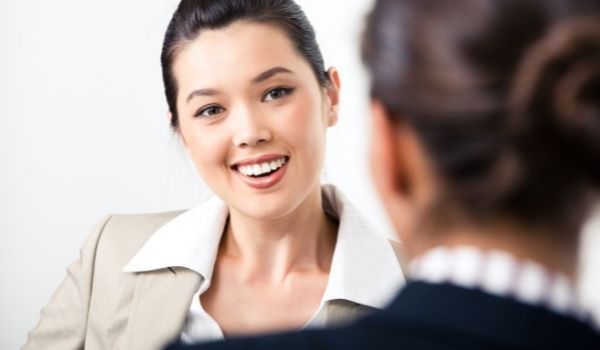 a woman speaking to another woman