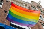 a lgbt community rainbow flag flying in amsterdam