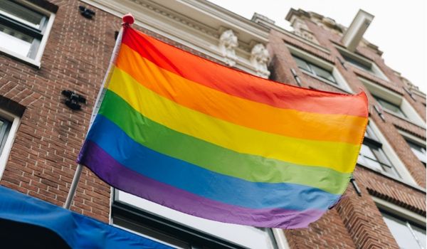 a lgbt community rainbow flag flying in amsterdam
