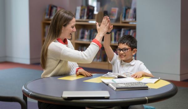 IB Tutor teaching a child one on one