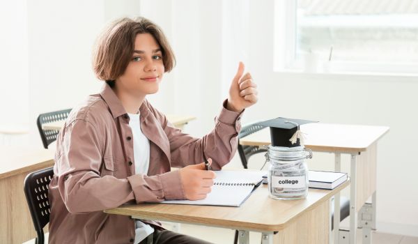 teenage boy giving the thumbs in the classroom
