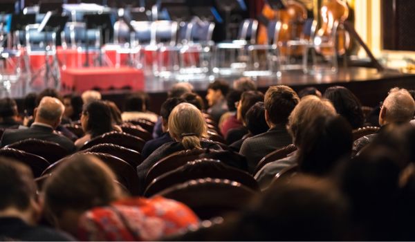 an audience waiting for a classical music concert to start in the netherlands