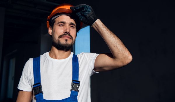 a migrant in the netherlands holding his helmet