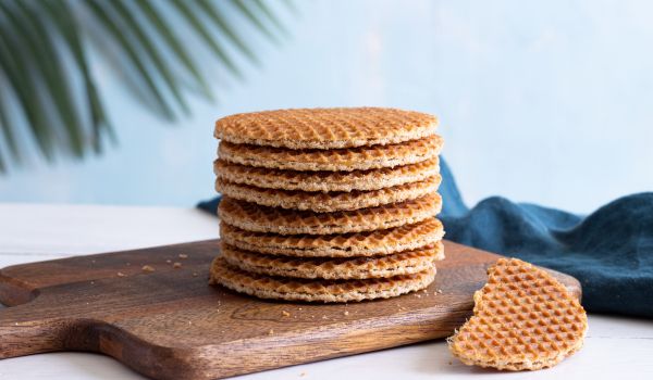 a stack of stroopwafels on a wooden board