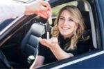 a woman in a car getting handed the keys after buying it using classifieds for cars in the netherlands