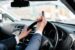 a man in a car giving the middle finger