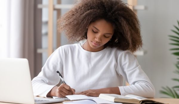 focused student writing an essay