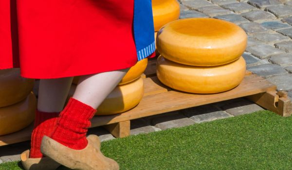 a woman standing in the gouda cheese market