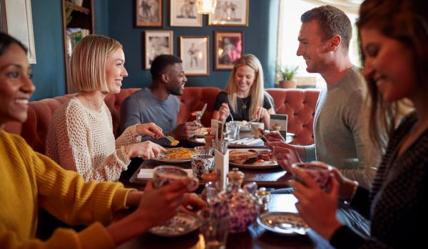 a group of people eating in a restaurant