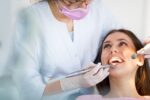 a dentist and her patient in the dental chair