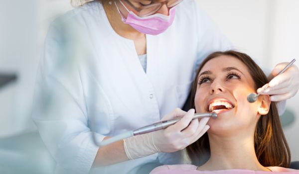 a dentist and her patient in the dental chair