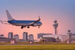 a klm plane descending onto schiphol airport in an increase for netherlands air travel