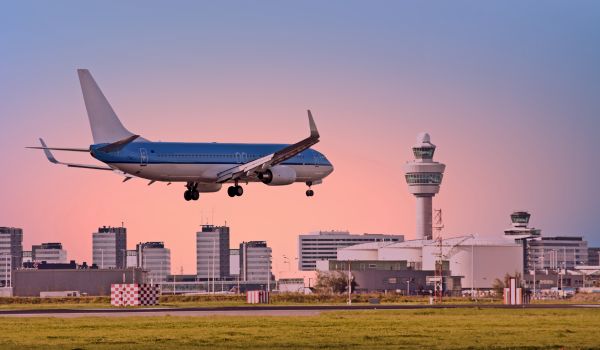 a klm plane descending onto schiphol airport in an increase for netherlands air travel