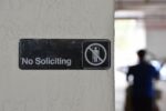 no soliciting sign on a wall