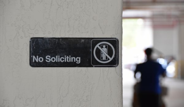 no soliciting sign on a wall