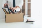 a man packing his things after being dismissed from workk