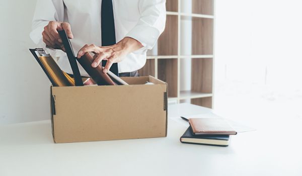 a man packing his things after being dismissed from workk