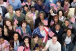 Crowd holding american flags representing the dutch-american friendship day