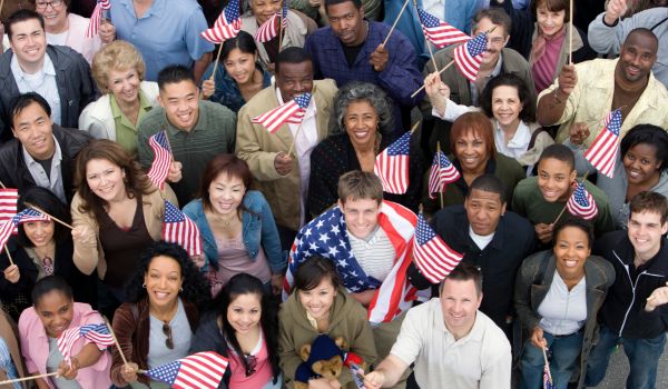 Crowd holding american flags representing the dutch-american friendship day