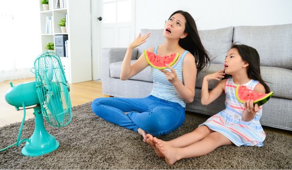 a mother and daughter sitting in the living room and are very warm