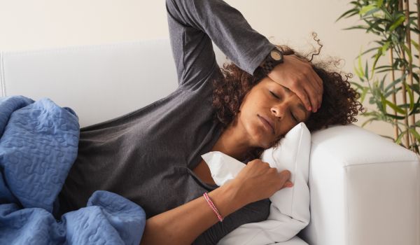 a woman sick on her couch