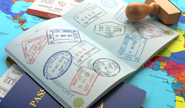 An open passport with several visa stamps