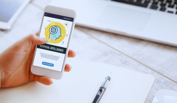 a hand holding a smartphone with an AI app