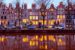 a row of dutch canal houses at dusk