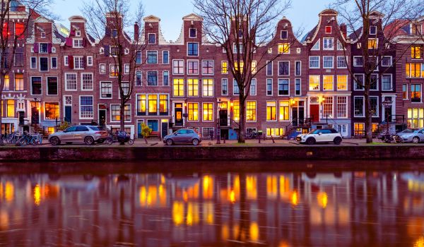 a row of dutch canal houses at dusk