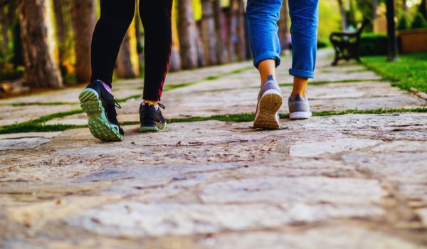 two sets of feet walking in the park