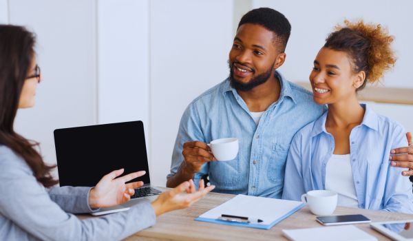 a young couple consulting a real estate agent