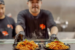 The chef at Siam Bowl serving Thai food in Amsterdam