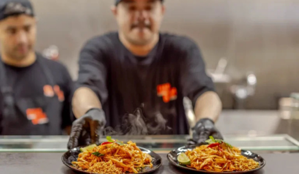 The chef at Siam Bowl serving Thai food in Amsterdam