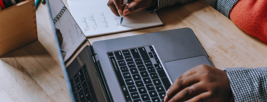 a woman taking notes on her laptop