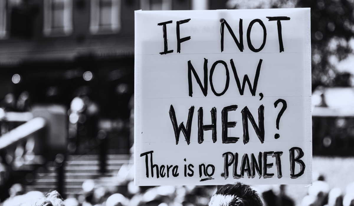 A sign at a climate change rally in black and white