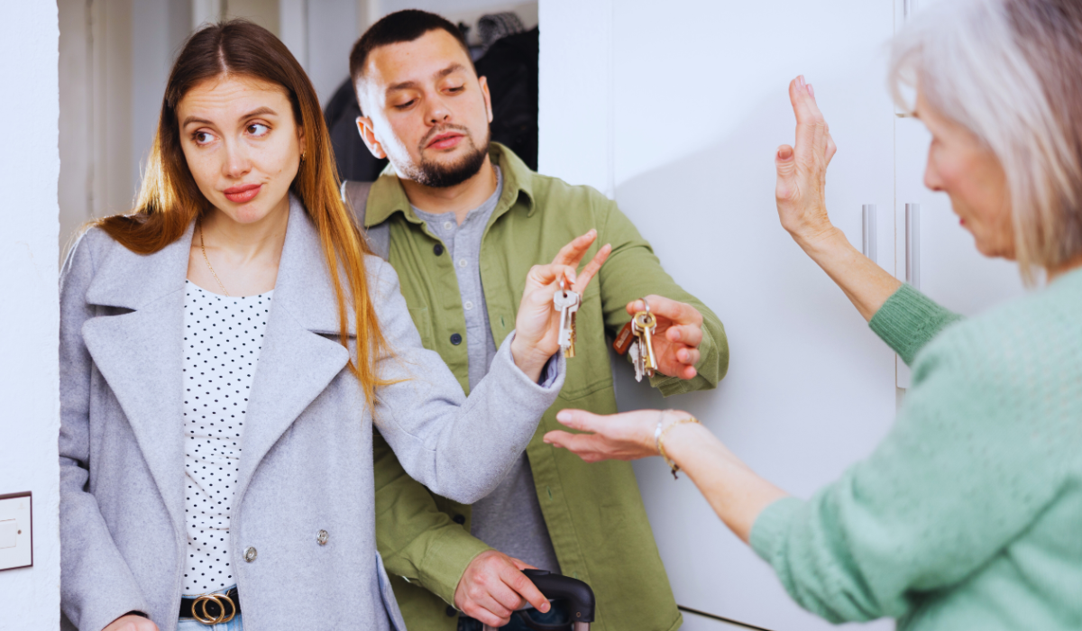 Dissatisfied landlord receiving keys from tenants