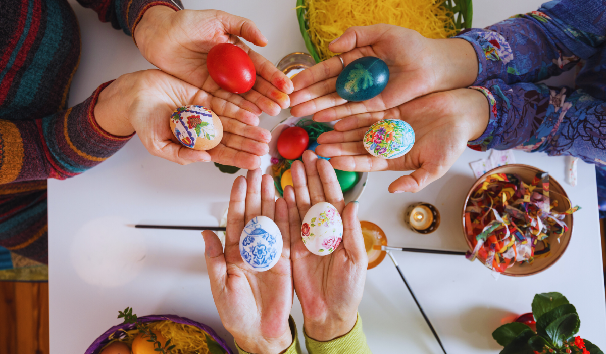 a group of friends painting easter eggs