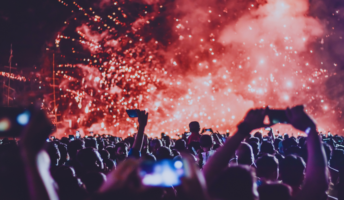 A crowd of people watching fireworks
