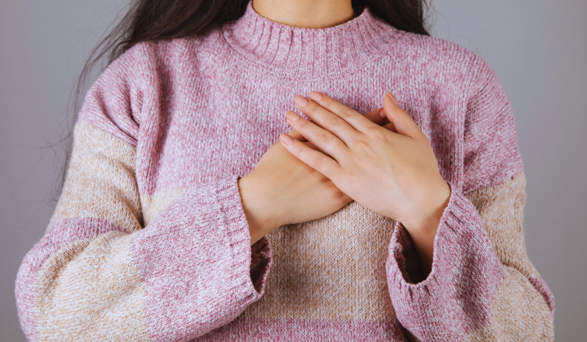 a woman with her hand on her heart