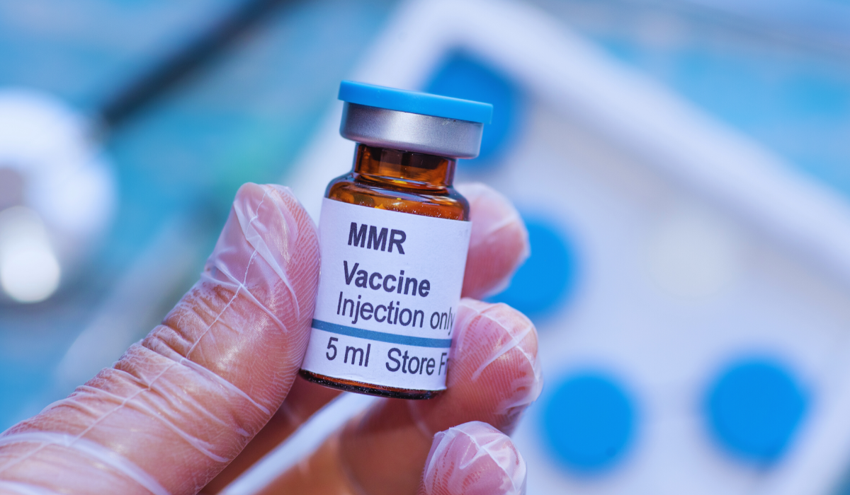 a hand holding the MMRR vaccine