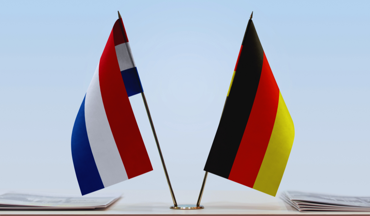 Dutch and German flags standing on a tabletop