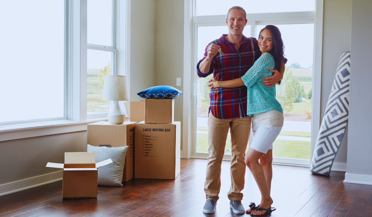 a couple of proud homeowners in their new home
