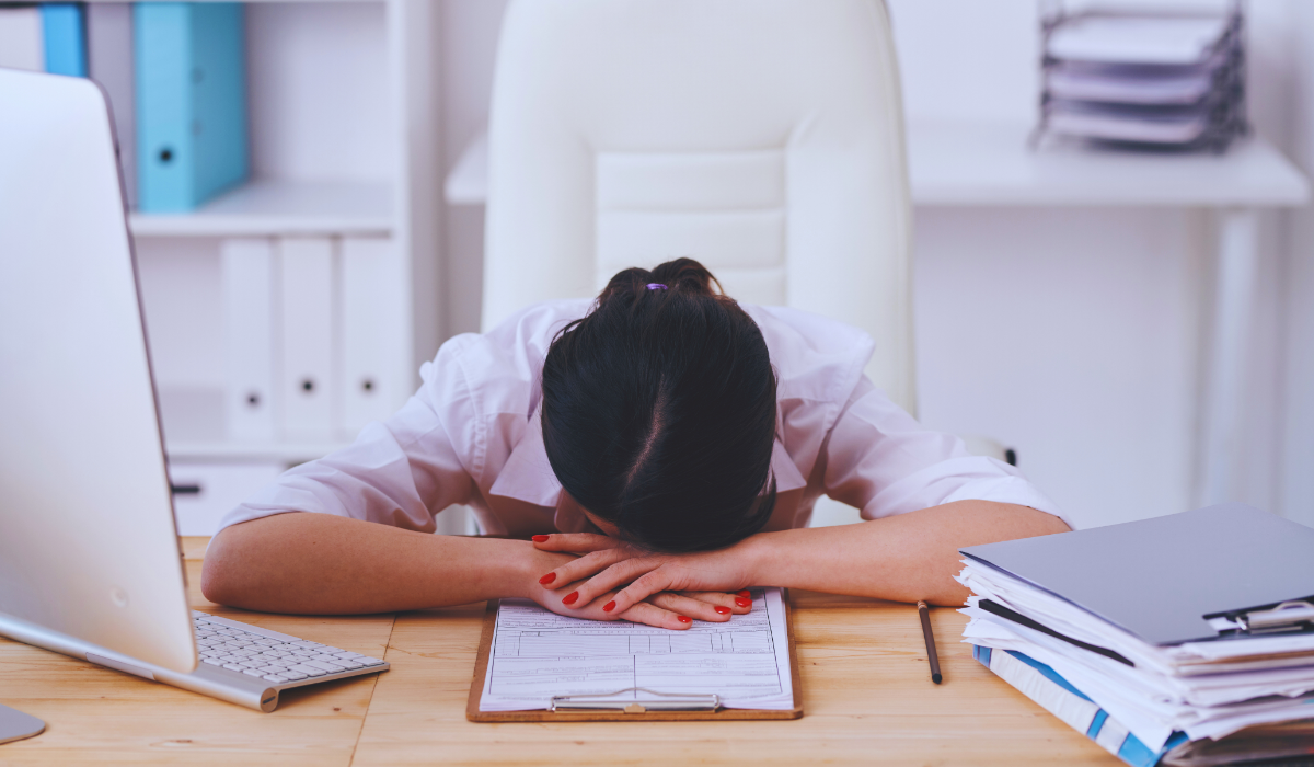 a woman tired at her laptop