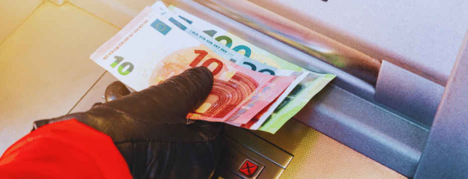 A woman taking money out of a Dutch ATM