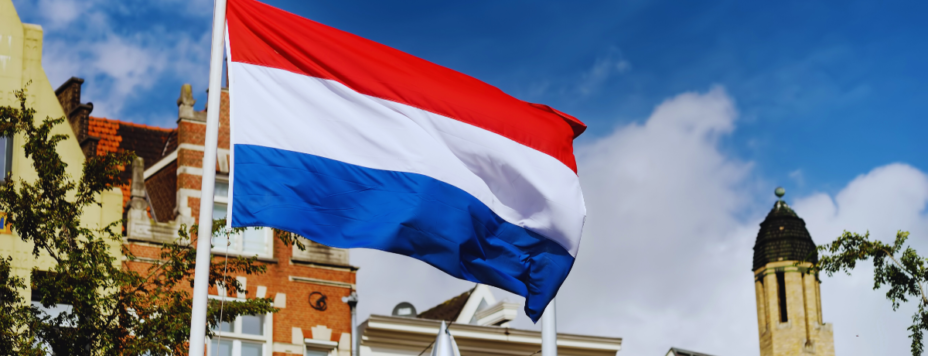 The Flag of the Netherlands against Dutch building tops