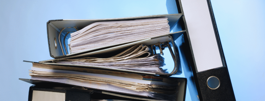 A stack of binders representing Bureaucracy